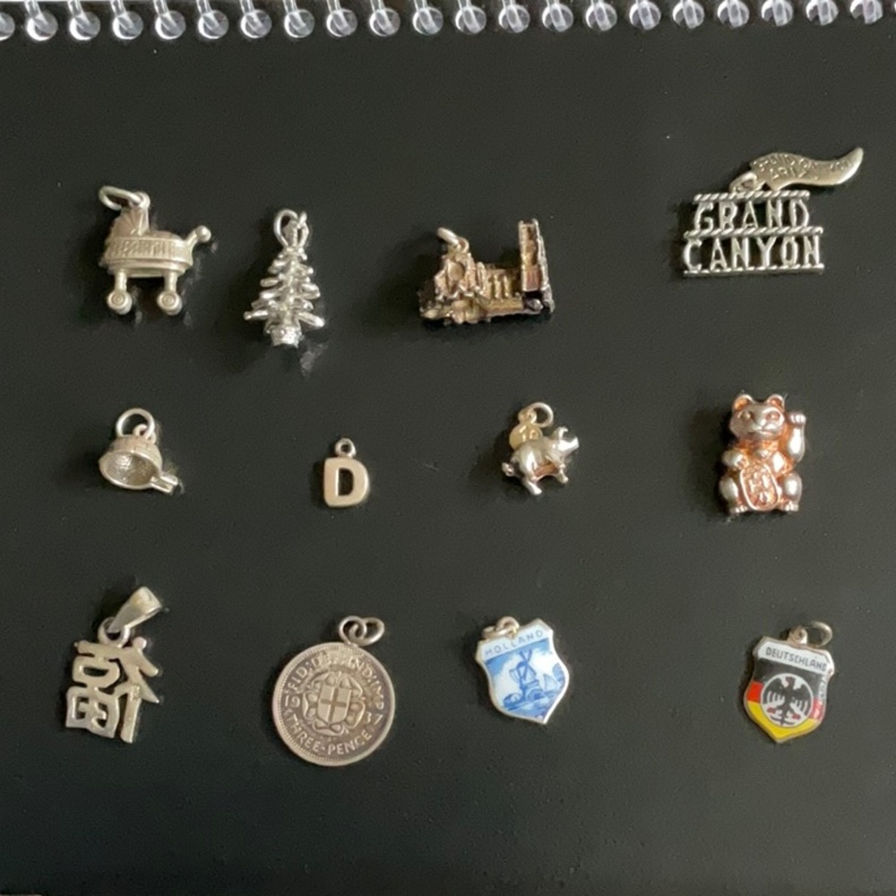 Collection of sterling silver vintage charms (12)
